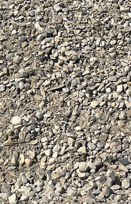 A Gravel mix of sand and crushed stone, ideal for driveways, pathways, and base layers in landscaping and construction projects from StoneKraft.ca.